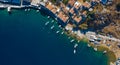 Aerial panoramic view on beautiful Greek houses on island hills, yacht sea port, tourist ferry boat at Aegean Sea bay. Greece Royalty Free Stock Photo