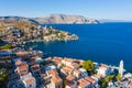 Aerial panoramic view on beautiful Greek houses on island hills, yacht sea port, tourist ferry boat at Aegean Sea bay. Greece Royalty Free Stock Photo