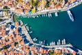 Aerial panoramic view on beautiful Greek houses on island hills, yacht sea port, tourist ferry boat at Aegean Sea bay. Greece Royalty Free Stock Photo
