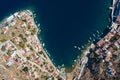 Aerial panoramic view on beautiful Greek houses on island hills, yacht sea port, tourist ferry boat at Aegean Sea bay. Greece Royalty Free Stock Photo