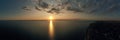 Aerial panoramic view of a beautiful nature landscape with dramatic clouds sunset sky and views of the sea surface Royalty Free Stock Photo