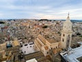 Aerial Panoramic View of the Belltower of the Cathedral of St. Maria La Bruna on Cloudy Sky at Sunset