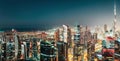 Aerial panoramic view of a big futuristic city by night. Business bay, Dubai