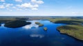 Aerial panoramic view of blue lake, islands and green forest on a sunny spring day. Drone photography.