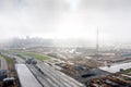 Aerial panoramic view of city construction site with crane in fog Royalty Free Stock Photo