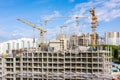 Aerial panoramic view of city construction site with tower cranes against blue sky Royalty Free Stock Photo