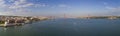 Aerial panoramic view of the city of Lisbon with sail boats on the Tagus River and the 25 of April Bridge Ponte 25 de Abril on t Royalty Free Stock Photo