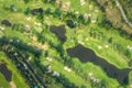 Aerial panoramic view drone shot of beautiful golf course with people playing golf in field Royalty Free Stock Photo