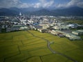 Aerial panoramic view of a factory with smoking chimneys by green rice paddies in Yilan Ilan Royalty Free Stock Photo