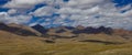 AERIAL: Panoramic view of clouds drifting over vast meadows and rocky Himalaya. Royalty Free Stock Photo