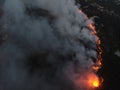 Aerial panoramic view of a forest fire at night, heavy smoke causes air pollution, and fire in full blaze. Natural