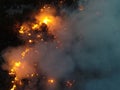 Aerial panoramic view of a forest fire at night, heavy smoke causes air pollution, and fire in full blaze. Natural