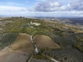 Aerial panoramic view on hills of Val d`Orcia near Bagno Vignoni, Tuscany, Italy. Tuscan landscape with cypress trees, vineyards, Royalty Free Stock Photo