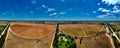 Aerial panoramic view of the irrigation of the cultivated farmland on a bright sunny day