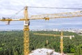 Aerial panoramic view of modern building under construction and yellow cranes against blue sky background Royalty Free Stock Photo
