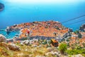 Aerial panoramic view of the old town of Dubrovnik with famous Cable Car on Srd mountain on a sunny day Royalty Free Stock Photo