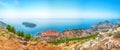 Aerial panoramic view of the old town of Dubrovnik with famous Cable Car on Srd mountain on a sunny day Royalty Free Stock Photo