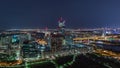 Aerial panoramic view over Vienna city with skyscrapers, historic buildings and a riverside promenade night timelapse in Royalty Free Stock Photo