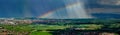Aerial panoramic view of the rainbow over the green valley