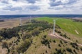 aerial panoramic view on rotating blades of windmill propeller on blue sky background. Wind power generation. Pure green energy Royalty Free Stock Photo