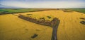 Aerial panoramic view of rural road passing through agricultural land in Australian countryside. Royalty Free Stock Photo