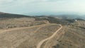 Aerial panoramic view of a scenic hilly dry valley surrounded by Canadian mountain landscape. Shot. Concept of Royalty Free Stock Photo