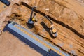 Aerial view of sewerge construction trench for laying external sewage drainage system construction at earthworks