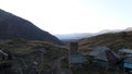 Aerial panoramic view of a small mountain village with old houses. Footage. Green and yellow autumn trees growing on one Royalty Free Stock Photo