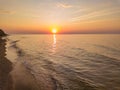 Aerial panoramic view of sunrise over sea. Nothing but sky, clouds and water. Beautiful serene scene Royalty Free Stock Photo