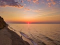 Aerial panoramic view of sunrise over sea. Nothing but sky, clouds and water. Beautiful serene scene Royalty Free Stock Photo