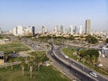 Aerial panoramic view of Tel Aviv. City buildings, well planned transport junction of highways, greenary, traffic and Royalty Free Stock Photo