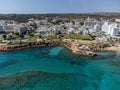 Aerial panoramic view on holidays resorts and blue crystal clear water on Mediterranean sea near Fig Tree beach, Protaras, Cyprus Royalty Free Stock Photo