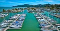 Aerial Paradise Cay Yacht Harbor boats on teal water with waterfront properties behind