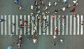 Aerial. Pedestrians passing a crosswalk. Rush hour in the city. People are rushing to work. Royalty Free Stock Photo