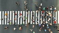 Aerial. People crowd. Many people going through the pedestrian crosswalk.