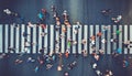 Aerial. People crowd motion through the pedestrian crosswalk. Top view from drone. Toned image