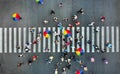 Aerial. People crowd on a pedestrian crossing crosswalk.