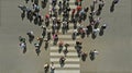 Aerial. People crowd on pedestrian crosswalk.