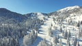 Aerial: People Skiing In Beautiful Snowy Soriska Planina Ski resort, Slovenia