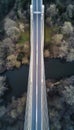 Aerial perspective of a bridge showcasing its linear geometry amidst a stunning landscape backdrop Royalty Free Stock Photo