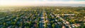 aerial perspective of a peaceful suburban neighborhood, with houses, parks, and tree-lined streets. Generative AI
