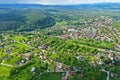 Aerial perspective view on sudety mountains with touristic city in the valley surrounded by meadows, forest and rapeseed fields Royalty Free Stock Photo