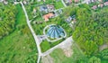 Aerial perspective view on touristic city with catholic church surrounded by meadows and forest