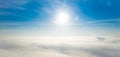 Aerial photo above the fog or white clouds with shining sun. Beautiful sunrise cloudy sky from aerial view. Above clouds from Royalty Free Stock Photo