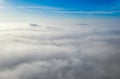 Aerial photo above the fog or white clouds with shining sun. Beautiful sunrise cloudy sky from aerial view. Above clouds from Royalty Free Stock Photo