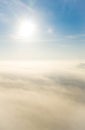 Aerial photo above the fog or white clouds with shining sun. Beautiful sunrise cloudy sky from aerial view. Above clouds Royalty Free Stock Photo