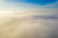Aerial photo above the fog or white clouds with shining sun. Beautiful sunrise cloudy sky from aerial view. Above clouds from Royalty Free Stock Photo