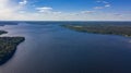 Aerial photo of the big lake in the forest with cumulus clouds
