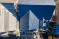 Aerial photo of building construction work being done on a property with scaffolding up at the property and roofers working on the