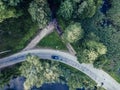 Aerial Photo of Car Driving on the Road going by the River under the Trees, Top Down View in Early Spring on Sunny Day - Concept Royalty Free Stock Photo